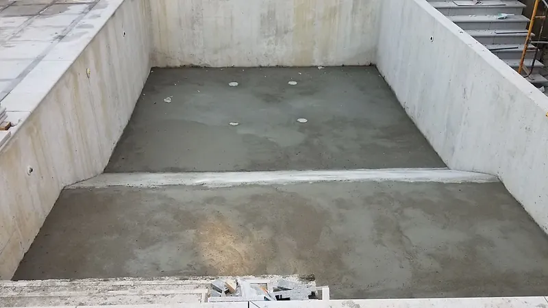 Outdoor concrete pool with a finished mortar floor in two levels and a step-down line